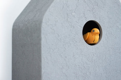 Cuckoo Clock - Concrete coated with black accessories and amber bird